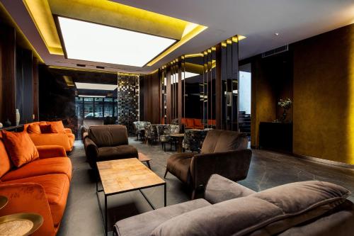 a living room with couches and chairs and a skylight at Seraphine Plaza in Peje