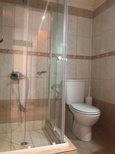 a bathroom with a toilet and a glass shower at Hotel Paradise in Kriopigi