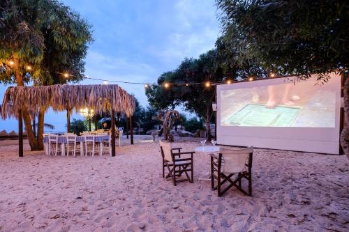 a projection screen on the beach with tables and chairs at Thalassines Villas in Ayia Napa