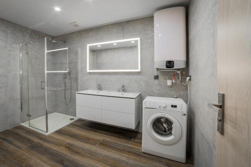 a bathroom with a washing machine and a shower at Apartmány pri vstupe do Aquaparku in Senec