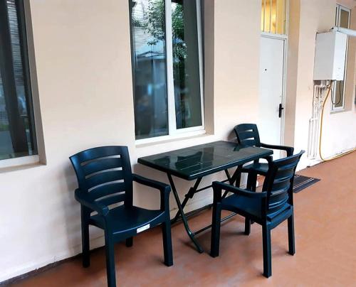 a black table and four chairs sitting next to a wall at Keti's Apartament Centre of Old Tbilisi in Tbilisi City