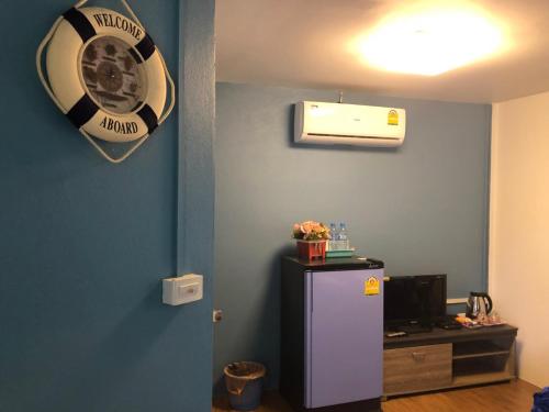 a room with a refrigerator and a fan on the wall at ทับศิลารีสอร์ท Tubsila Resort in Chongsadao