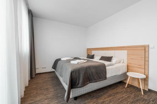 a bedroom with a large bed and a table at Apartmány pri vstupe do Aquaparku in Senec