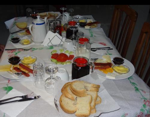 a table with plates of food on top at Haris Hotel in Vlorë