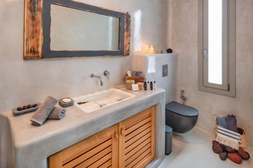 a bathroom with a sink and a toilet at MILESTONE VILLAS in Megalokhori