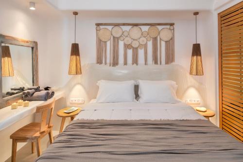 a bedroom with a large bed and a mirror at MILESTONE VILLAS in Megalokhori