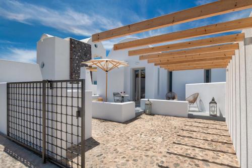 a patio in a villa with a wooden pergola at MILESTONE VILLAS in Megalokhori