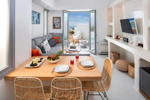 a dining room and living room with a table and chairs at MILESTONE VILLAS in Megalokhori
