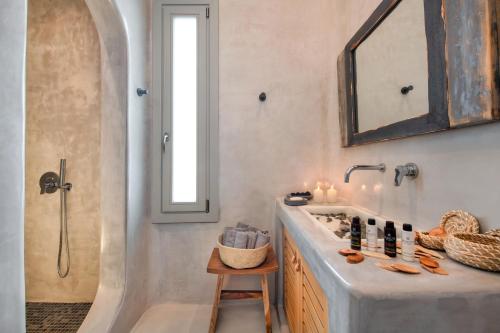 a bathroom with a sink and a shower at MILESTONE VILLAS in Megalokhori