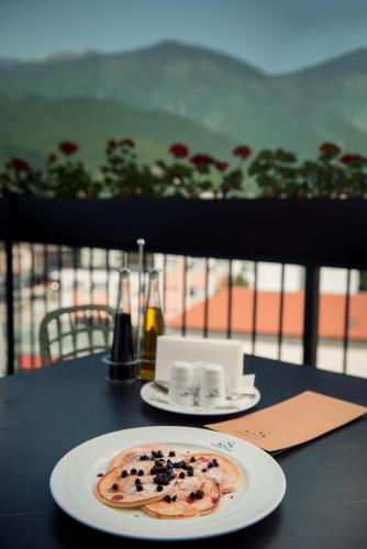 a plate of food sitting on top of a table at Seraphine Plaza in Peje