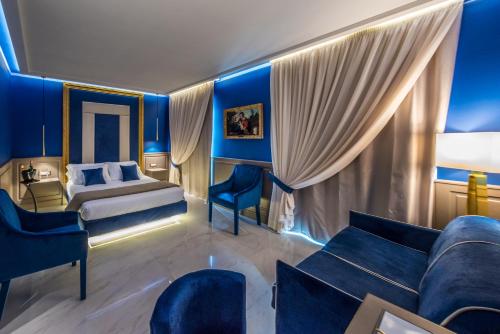 a hotel room with a bed and a couch at Relais San Severo in Naples