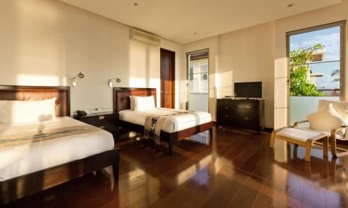 Ένα ή περισσότερα κρεβάτια σε δωμάτιο στο Sanur Residence