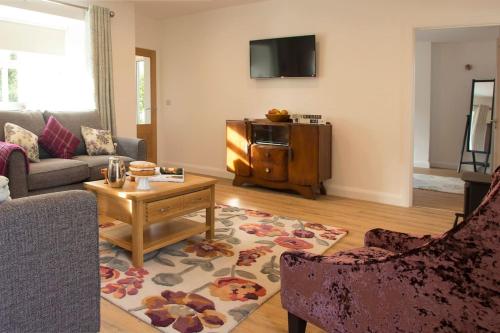 a living room with a couch and a table at Bramble Cottage in Rathfriland