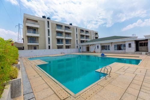 a large swimming pool in front of a building at Vivaant Retreat and Conventions in Igatpuri