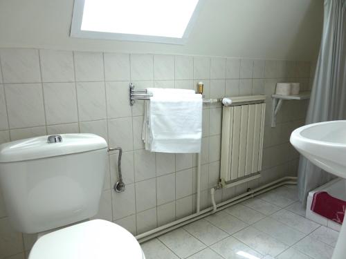 a bathroom with a toilet and a sink at Quiet room in Budapest near airport with free parking in Budapest