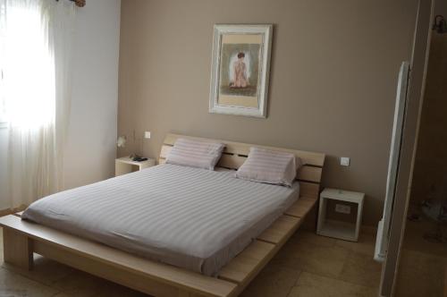 - une chambre dotée d'un lit avec des draps blancs dans l'établissement Villa, à Combas