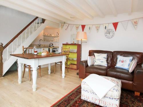 a living room with a table and a couch at Big House in Llandecwyn