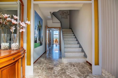 a staircase in a home with yellow walls at Pensión Casa do Gallo Sarria in Sarria