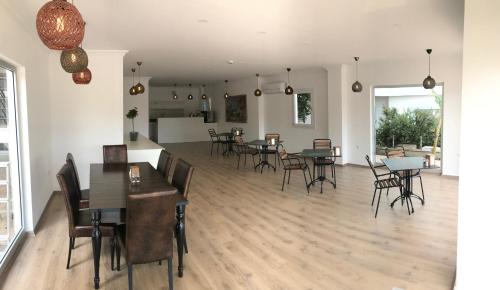 a dining room with tables and chairs in a room at dekatria rooms&aparts in Kas