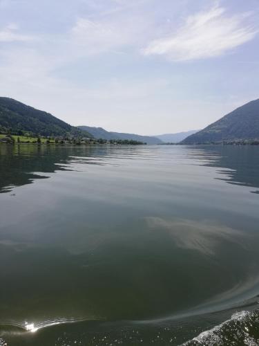 a large body of water with mountains in the background at Ferienhaus Am-moore in Steindorf am Ossiacher See