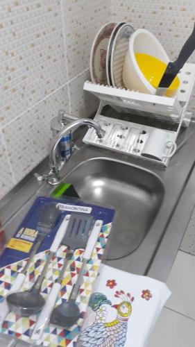 a sink with some kitchen utensils on it at Boa vista, Olímpico - Apartamento mobiliado in Boa Vista