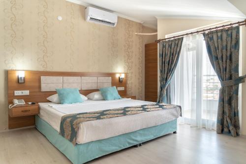Postel nebo postele na pokoji v ubytování OLYMPIC HOTELS Belek