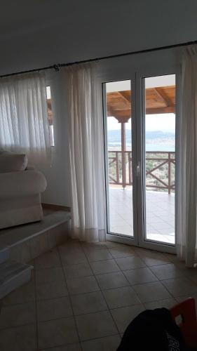 a room with a sliding glass door with a balcony at Ionian Balcony - Davgata in Dhavgáta