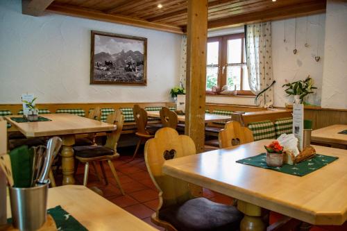 a dining room with wooden tables and chairs at Ferienwohnungen im Dorfwirt in Blaichach
