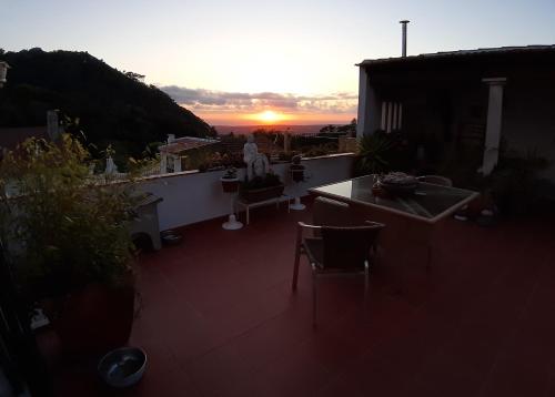 a view of a balcony with the sunset in the background at Isa's Home in Sintra