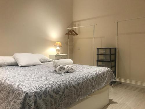 a bedroom with a bed with towels on it at APARTAMENTO VALLEHERMOSO in Madrid