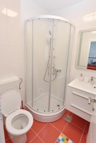 a bathroom with a shower and a toilet and a sink at Apartman MiR in Šibenik