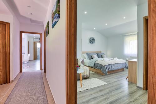 a bedroom with a bed and a living room at Apartments and rooms Hope in Slunj