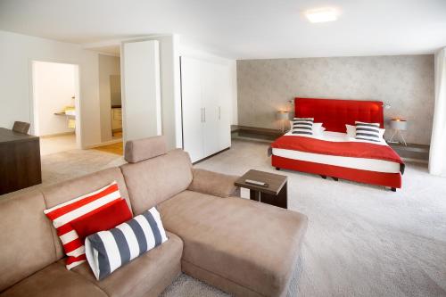 a living room with a bed and a couch at Boardinghouse by M&K in Bad Oeynhausen