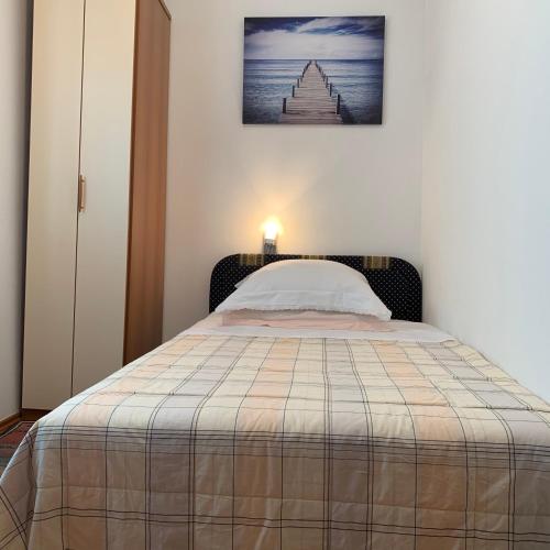 a bedroom with a bed with a picture on the wall at Apartment Excellent in Nečujam