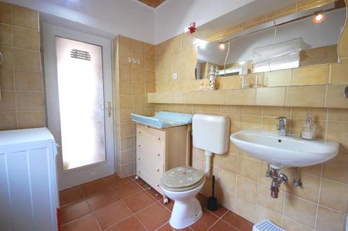 a bathroom with a toilet and a sink at Apartment Iskra in Njivice