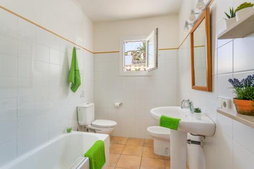 a bathroom with a tub and a toilet and a sink at Villa BiniLlor by Mauter Villas in Binissafuller