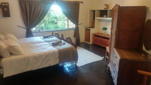 een slaapkamer met een groot bed en een raam bij A Night at the Museum in Johannesburg