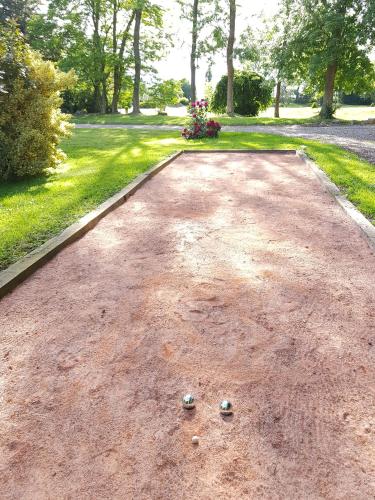 a driveway with two golf balls on the ground at Château de Cleuville in Cleuville
