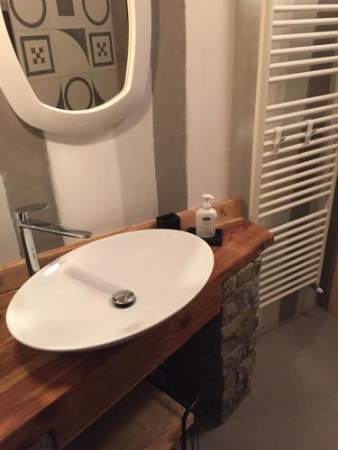 a bathroom with a white sink and a mirror at Camera Milla - private room -T04416 in Temù