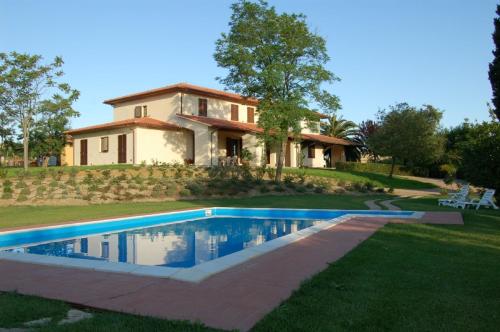 uma casa com piscina em frente a uma casa em Agriturismo Il Poggiolo em Grosseto