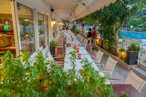 a long row of tables and chairs in a restaurant at Missiria Apartments in Rethymno Town