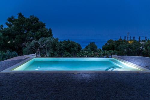 a swimming pool in a yard at night at Villa Melite in Agios Nikolaos