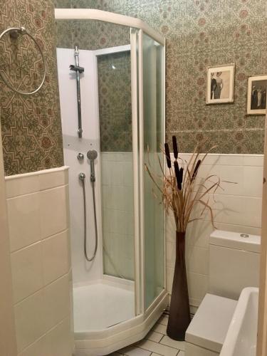 a shower with a glass door in a bathroom at Pensionat Kanalvillan in Väddö