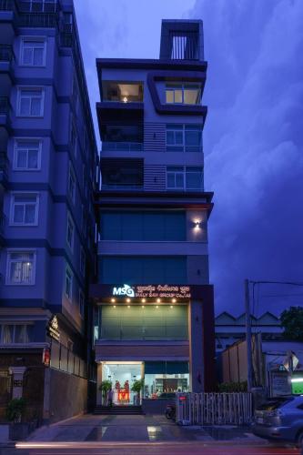 a tall building with a sign in front of it at SSB Residence in Phnom Penh