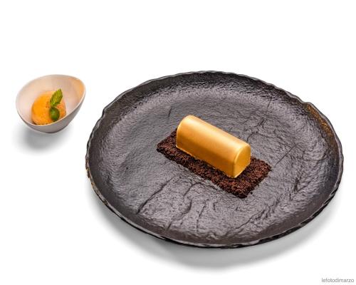 a black plate with a piece of food on top at Grand Hotel Sitea in Turin