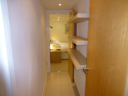 a small room with a hallway leading to a bedroom at Earle House Serviced Apartments in Crewe