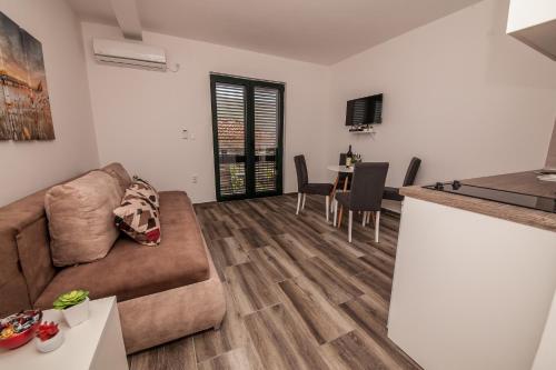 a living room with a couch and a table at Blue Sea in Herceg-Novi