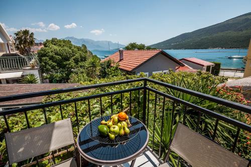 a bowl of fruit on a table on a balcony at Blue Sea in Herceg-Novi