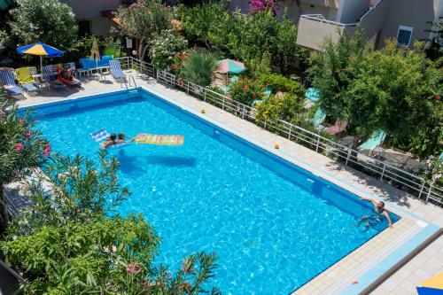 an overhead view of a swimming pool with two people in it at Missiria Apartments in Rethymno Town