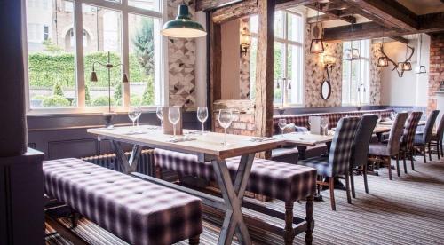 a dining room table with chairs and tables at De Trafford Arms by Chef & Brewer Collection in Alderley Edge